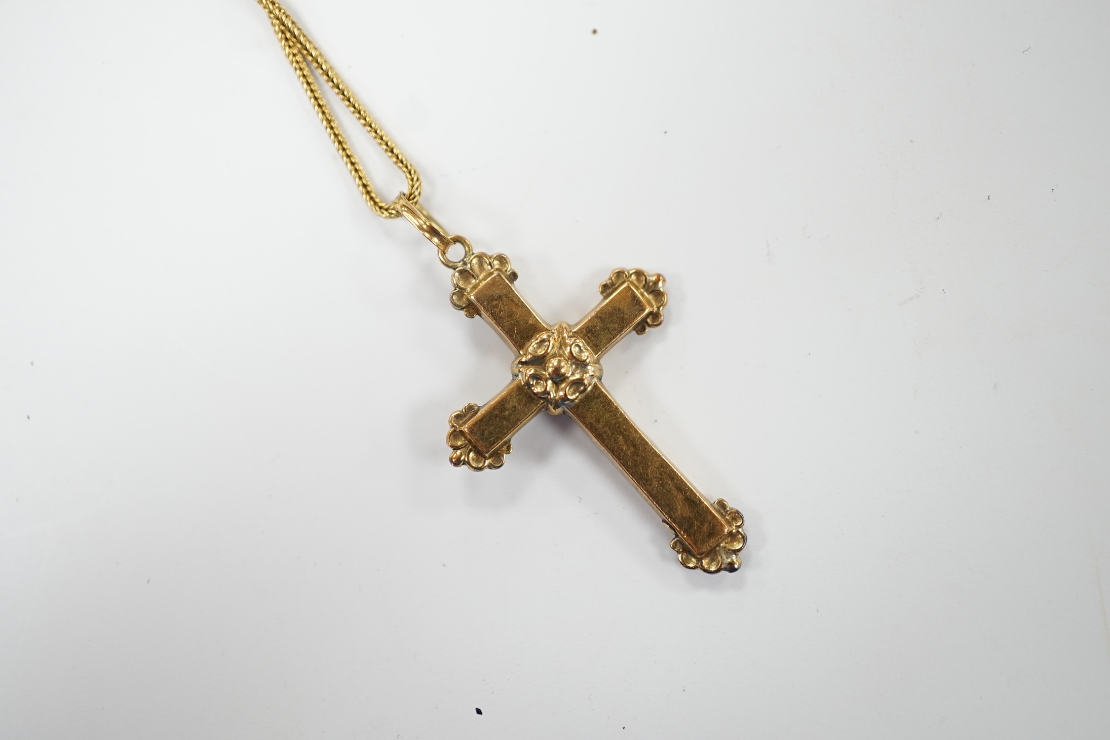 A yellow metal, black enamel and seed pearl set cross pendant, 30mm, on a yellow metal fine link chain, 38cm, gross weight 4.2 grams. Fair condition.